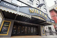 Elegant theater entrance with prominent marquee and stylish architectural details, inviting patrons to an exciting cultural experience.
