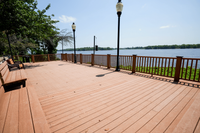 Inviting riverside deck with charming benches, picturesque views, and elegant lantern lighting for serene relaxation.