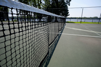 Inviting outdoor tennis court with scenic lake views, perfect for recreation and relaxation.
