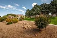 Charming landscaped outdoor area with lush greenery and scenic mountain views, perfect for tranquil living.