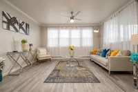 Bright and sophisticated living room with modern decor, elegant flooring, and plush seating, creating a cozy and stylish ambiance.