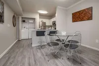 Modern apartment interior with sleek kitchen, elegant dining area, and convenient in-unit laundry.