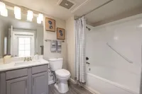 Elegant bathroom featuring modern fixtures, stylish lighting, and a calming gray color scheme.