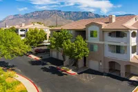 Beautiful apartment building surrounded by lush greenery with scenic mountain views, offering a peaceful suburban lifestyle.