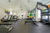 Modern fitness center with state-of-the-art equipment, colorful decor, and ample natural light.