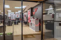Glass-front leasing office with comfortable seating and modern decor.