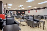 Modern lounge space with comfortable seating, bright lighting, and sleek decor.
