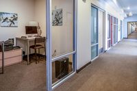 Media Room Bright hallway displaying a cozy corner office space with modern decor.