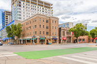 Charming urban street corner with diverse dining and vibrant new development, perfect for city living.