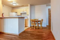 Warm and inviting kitchen with wooden cabinetry and charming dining nook, ideal for cozy meals and gatherings.