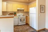 Charming kitchen with light wood cabinetry, modern appliances, and cozy decor, perfect for culinary creativity.