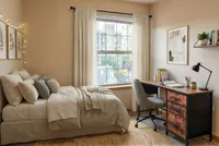 Cozy and bright bedroom with a large window view, featuring a comfortable bed, stylish decor, and a spacious desk perfect for working or studying.