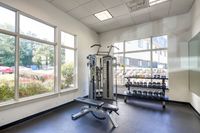 A well-equipped gym at Butler Ridge Apartments featuring weights and various exercise machines for fitness enthusiasts.