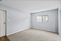 Bright and inviting room with fresh carpet and ample natural light, ideal for a cozy living space.