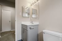 Chic apartment bathroom featuring modern vanity with sleek mirrors and elegant lighting.