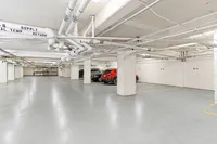 Modern underground parking garage with ample space, freshly painted floor, and sleek design.