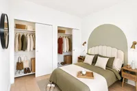 Elegant bedroom with modern design features a cozy bed, stylish nightstands, and a spacious closet for ample storage.