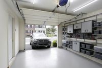 Modern, well-organized garage featuring abundant storage solutions and sleek vehicle access.