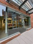 Modern building entrance featuring expansive glass windows and stylish brick facade at 520 Park.