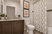 Elegant bathroom with modern vanity, chic decor, and inviting shower area, perfect for relaxation.