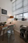 Bright and inspiring study nook with a sleek wooden desk, modern metal chair, and organized bookshelf. Perfect for focused work sessions.