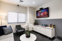 Chic lounge area with cozy seating, modern decor, and a wall-mounted TV perfect for entertainment.