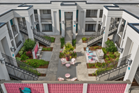 Charming apartment courtyard featuring stylish outdoor seating, lush greenery, and modern architecture, perfect for relaxation and community gatherings. Charming apartment courtyard featuring stylish outdoor seating, lush greenery, and modern architecture, perfect for relaxation and community gatherings.