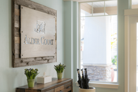 Inviting entrance of Alder Court with stylish wooden decor and natural light streaming in through large windows.