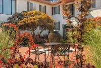 Your peaceful courtyard escape—perfect for relaxing under the trees.