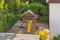 A cozy, shaded playground designed for safe, outdoor fun.