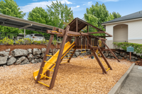 Family-friendly playground with swings and a slide, perfect for outdoor fun.