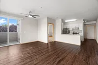 Open-concept living space with modern finishes and balcony access.