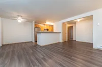 Spacious open-concept layout with a modern kitchen and wood-style flooring.