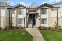 Renovated apartment homes at Boardwalk at University Place featuring landscaped grounds and convenient central building entrances.