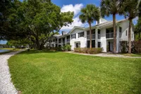 Tradition at Palm Aire apartment building and pathways on sunny day