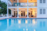 Tradition at Palm Aire exterior pool and patio area at dusk