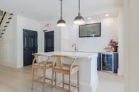 Tradition at Palm Aire kitchen island with sink and chairs in clubroom