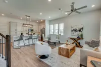 furnished and decorated living room and kitchen with wood style flooring