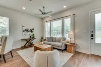 furnished and decorated living room and kitchen with wood style flooring