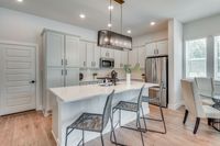 furnished and decorated living room and kitchen with wood style flooring