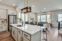 furnished and decorated living room and kitchen with wood style flooring