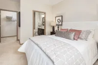 Luxurious bedroom suite with plush bedding, stylish decor, and an en-suite bathroom.