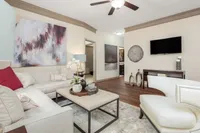 Sophisticated living room with modern decor, abstract art, and comfortable seating.