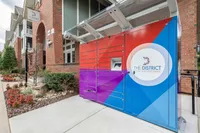 Contemporary apartment complex with modern package locker system at The District Luxury Apartment Homes.