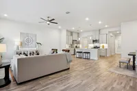 living area with wood style flooring and tall ceilings
