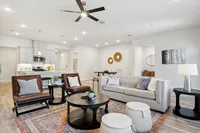 Furnished living area with vaulted ceilings next to upscale kitchen