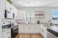Sanctuary at Indian Creek Furnished kitchen with white cabinetry