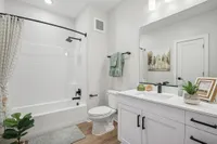 Guest bedroom with large vanity and tub/shower combo