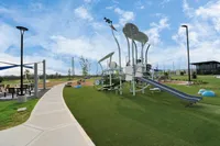 Villas at Sunterra 3-Bedroom Single Family Homes For Rent In Katy, TX - Villas At Sunterra - Exterior Shot Of The Playground Featuring A Slide, Swings, And Obstacles