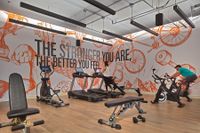 Luna at Viera Two-Bedroom Luxury Apartments Viera FL - Luna At Viera - Fitness Center Featuring Cardio Machines And Bold Wall Art